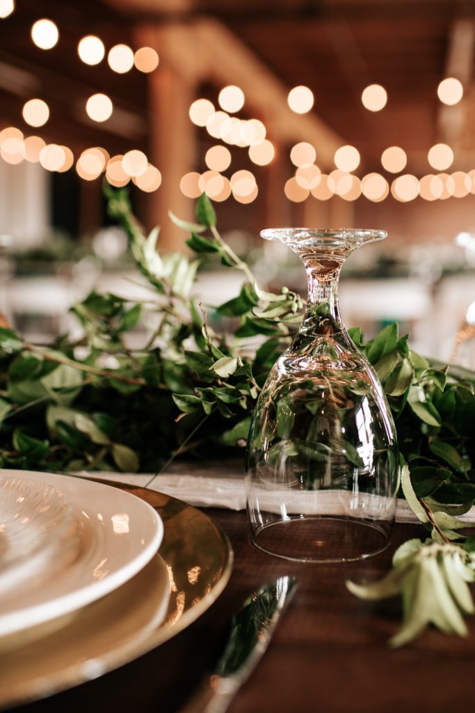 Wine glass set up on a farm house table at a wedding reception