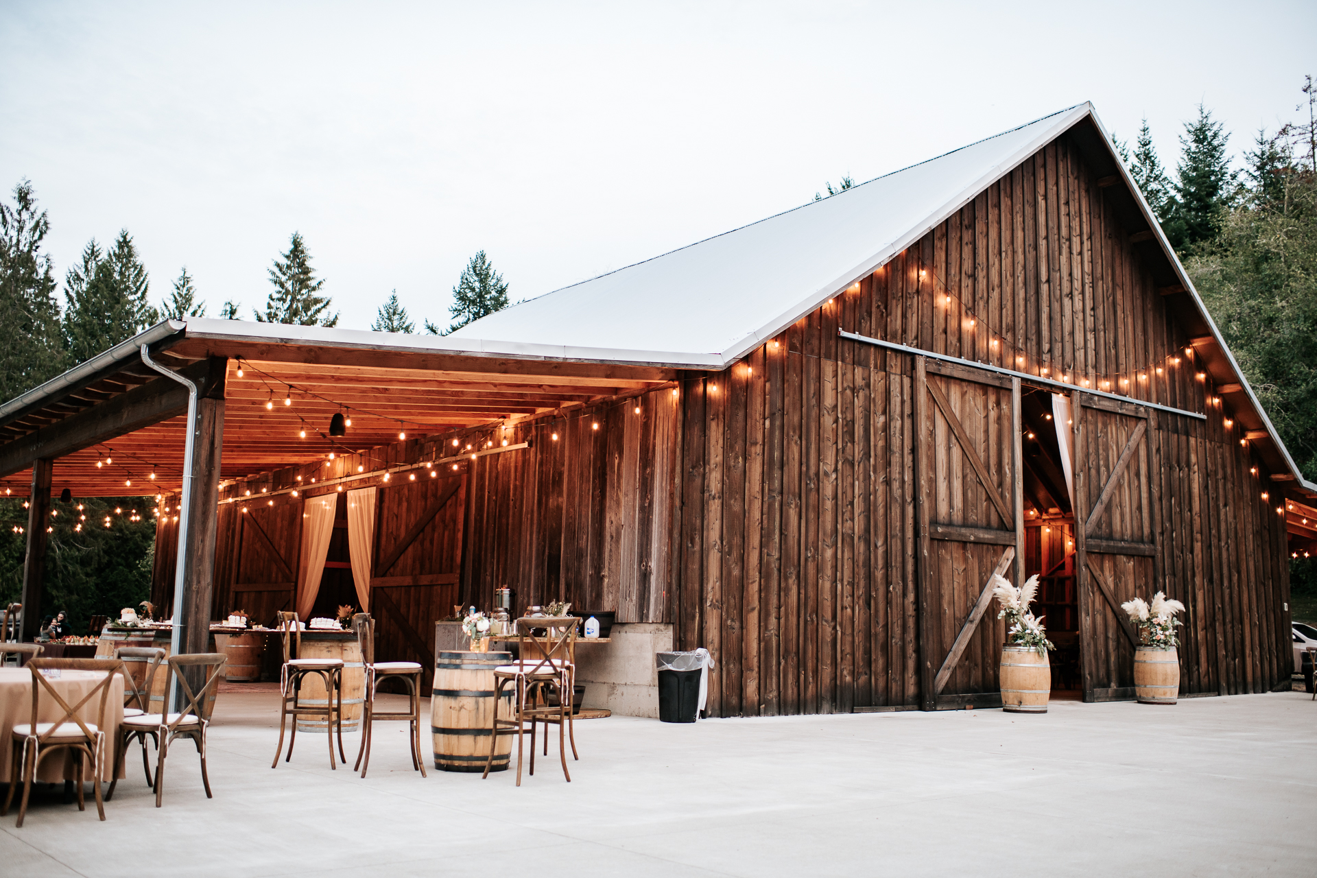 Large barn with string lights and boho wedding decor