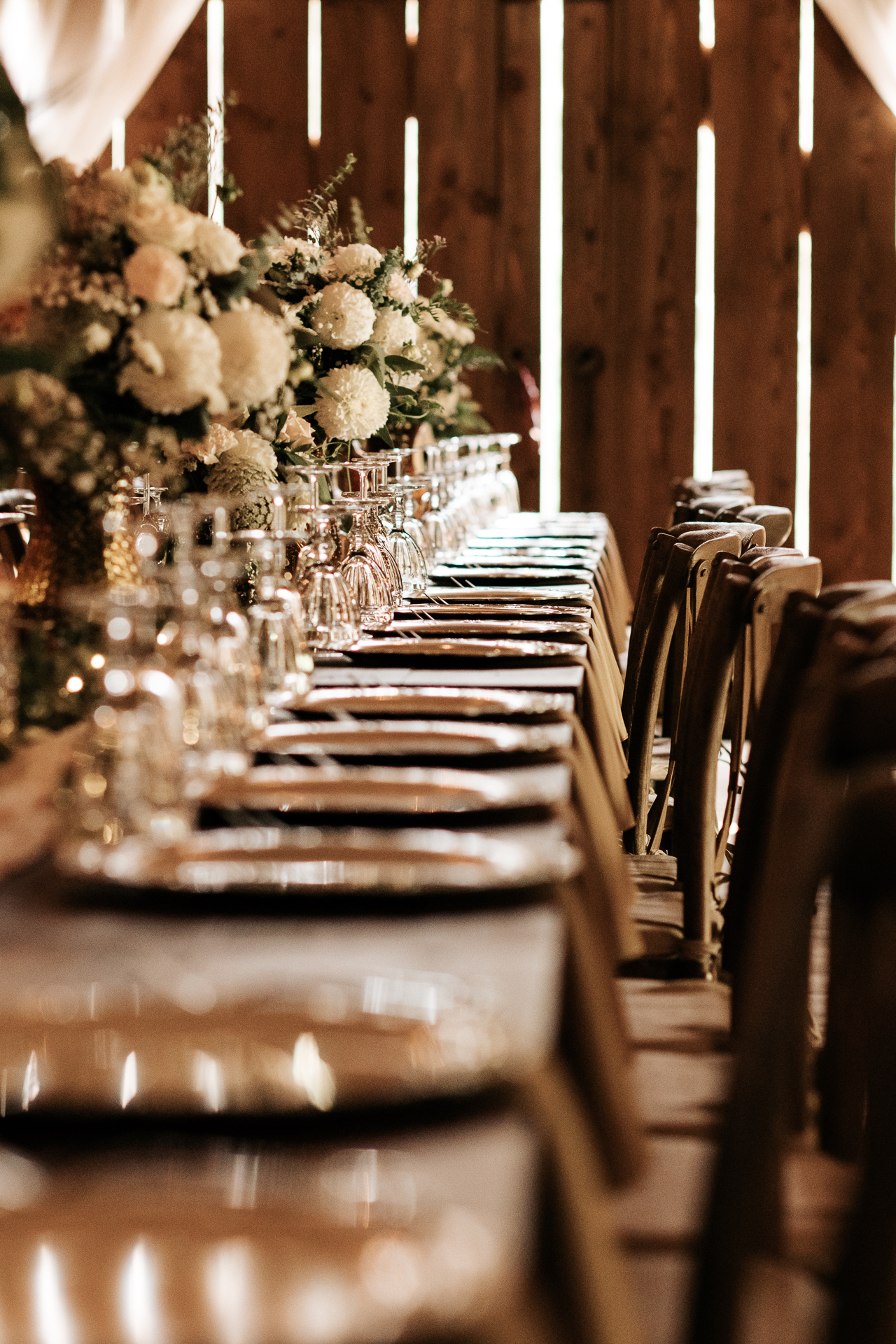 Shallow depth of field photo of place settings at a elegant barn wedding 
