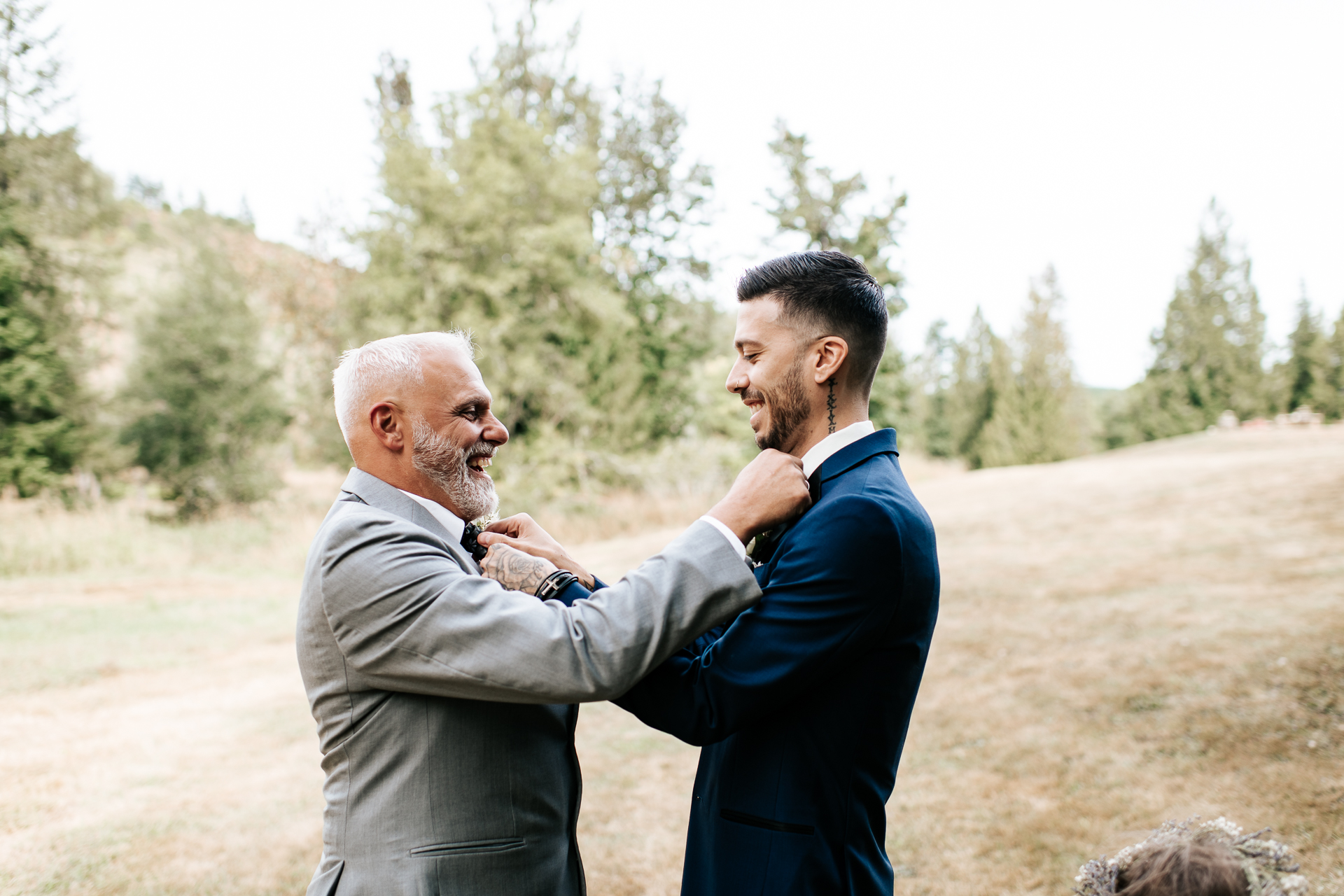 Father of the Bride and Groom adjust each others ties