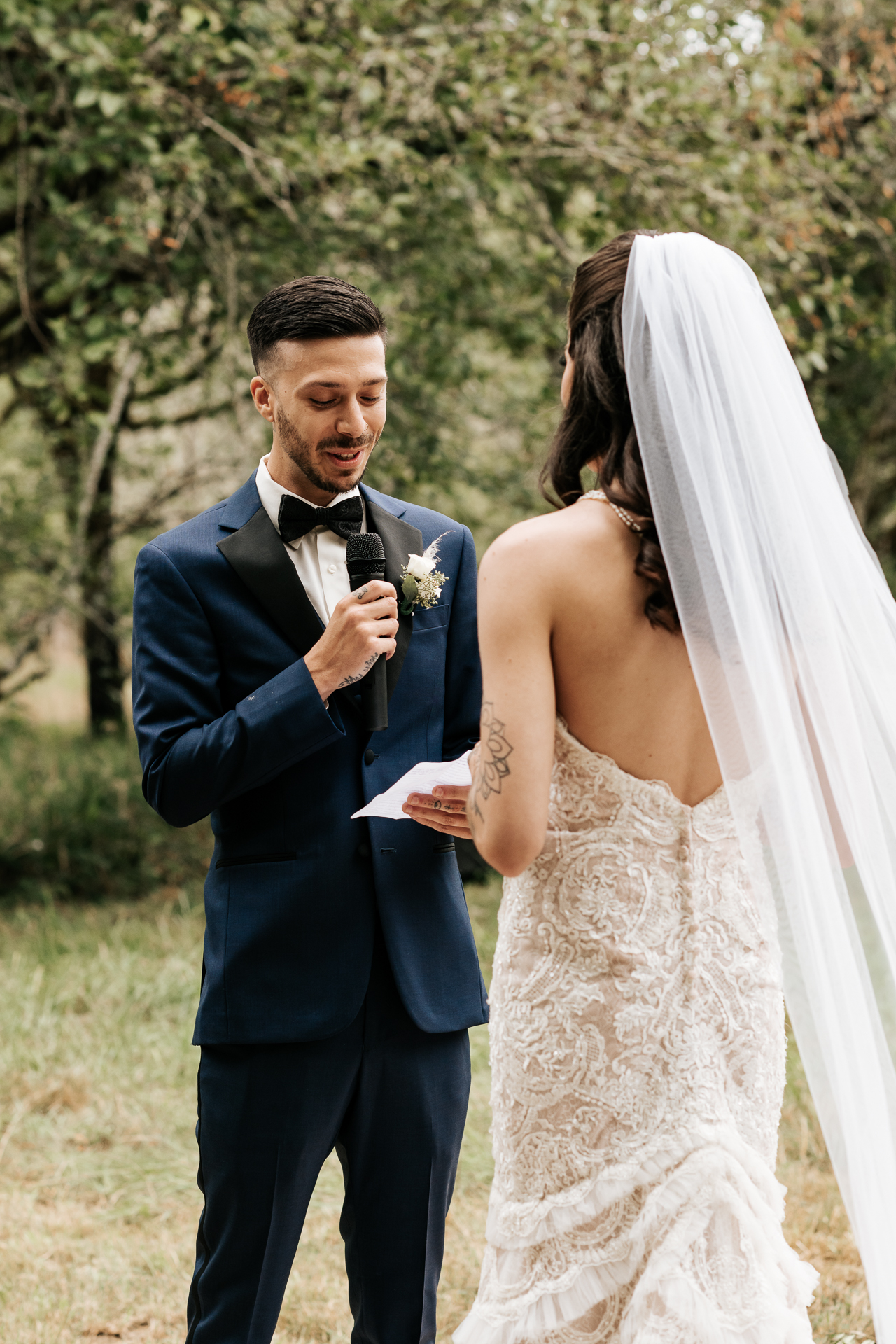 Groom reading his vows at their wedding ceremony