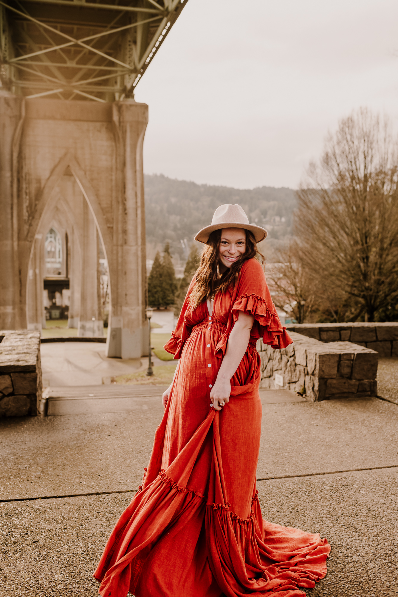 Pregnant mother wearing a red boho maternity dress